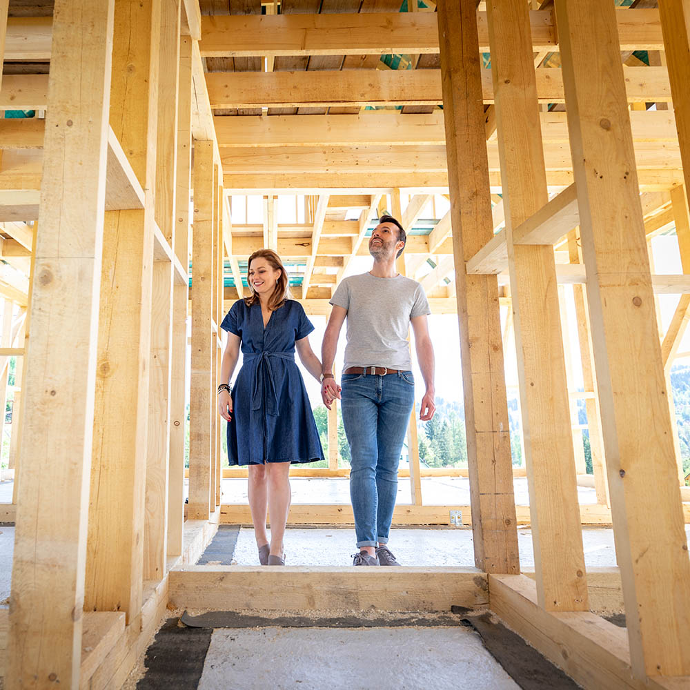 Loving couple at construction site of their new home dreams come true