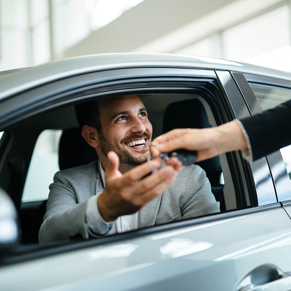 Portrait of happy customer buying new car